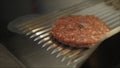 Cooking burgers on hot grill with flames Royalty Free Stock Photo