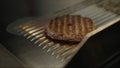 Cooking burgers on hot grill with flames Royalty Free Stock Photo