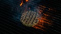 Cooking burgers patty on hot grill with flames. Burger preparation Royalty Free Stock Photo