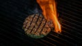 Cooking burgers patty on hot grill with flames. Burger preparation Royalty Free Stock Photo