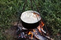 Cooking campfire soup Royalty Free Stock Photo