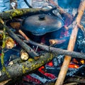 Cooking at the campfire . The stool stands in the center of the fire