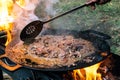 Cooking in a camping cast iron saj