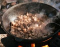 Cooking in a cauldron on open air on a summer day. Roasting meat in kazan over a fire. Traditionally a way of cooking.