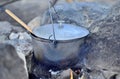 Cooking in a cauldron on an open fire. Preparing food at the sta Royalty Free Stock Photo