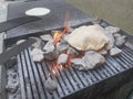 Cooking chapati roti on an open stove. Outdoor food preparation. Royalty Free Stock Photo