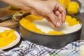 Cooking cheesecake. The cook decorates the cheesecake with sliced fruit. Woman decorates cheesecake