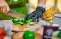 Cooking, Chef Cutting cucumber on hardboard and healthy food, Cutting cucumber slices on board with a sharp knife close Royalty Free Stock Photo