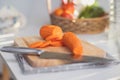 Cooking - Chef's hands are chopping carrots on the chopping board in the kitchen. Royalty Free Stock Photo