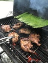 Cooking chicken barbeque using charcoal Royalty Free Stock Photo