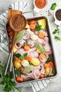 Cooking chicken bouillon or roast in cooking pan or pot with vegetables potatoes, carrots and herbs on kitchen grey concrete Royalty Free Stock Photo