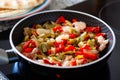 Cooking of chicken fajitas with sliced peppers and onions on fry pan Royalty Free Stock Photo