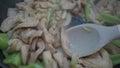 Cooking Chicken Stirfry with Vegetables in a Pan involves stirfrying ingredients on a stovetop