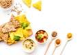 Cooking chickpeas. Bowl with hummus among pieces of crispbread and spices on white background top view copy space