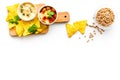 Cooking chickpeas. Bowl with hummus among pieces of crispbread and spices on white background top view copy space