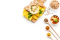 Cooking chickpeas. Bowl with hummus among pieces of crispbread and spices on white background top view copy space