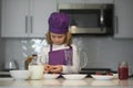 Cooking child. Chef child in apron and chef hat cooking at kitchen. Healthy food. Royalty Free Stock Photo