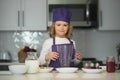 Cooking child. Kid making tasty delicious. little boy in chef hat and an apron cooking in the kitchen. Royalty Free Stock Photo