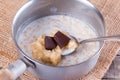 Cooking chocolate oatmeal porridge in a saucepan Royalty Free Stock Photo