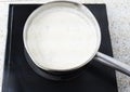 Cooking chocolate oatmeal porridge in a saucepan on a cooker Royalty Free Stock Photo