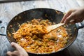 Cooking chongqing vegetables in wok at home