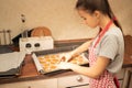 Cooking Christmas dessert ginger cookies, gingerbread, Girl puts figures for baking in the oven Royalty Free Stock Photo