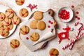 Cooking Christmas gingerbread. Decorating red nosed reindeer cookies with chocolate buttons and melted chocolate. Royalty Free Stock Photo