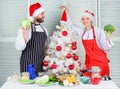 Cooking christmas meal. Man and woman chef santa hat near christmas tree. Secret ingredient is love. Christmas recipe Royalty Free Stock Photo