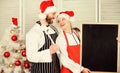 Cooking christmas meal. Christmas recipe concept. Menu for our family. Man and woman chef santa hat near christmas tree