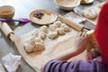 Cooking class, culinary. Food and people concept, molding of dough, child hands in process of molding, cooking of pie Royalty Free Stock Photo