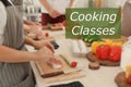 Cooking classes. Blurred view of people preparing meat in kitchen