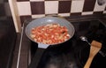 Cooking the classic Israeli food shakshuka from tomatoes and eggs