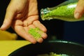 Cooking close up, adding coriander