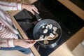 Close up picture of a housewife stirring food on a frying pan