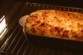 Cooking comfort food and traditional English cuisine, fish pie baking in the oven in countryside kitchen, homemade Royalty Free Stock Photo