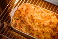 Cooking comfort food and traditional English cuisine, fish pie baking in the oven in countryside kitchen, homemade Royalty Free Stock Photo