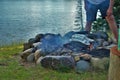Cooking corn on a camp fire next to the lake Royalty Free Stock Photo