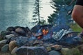 Cooking corn on a camp fire next to the lake Royalty Free Stock Photo