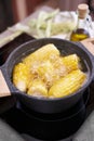 Cooking corn cob in a pot of boiling water with bubbles Royalty Free Stock Photo