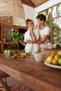 Cooking. Couple Preparing Fresh Organic Vegetables For Salad. Man Hugs Woman At Kitchen In Tropical Villa. Healthy Diet.