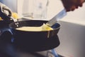 Cooking of crepe or thin pancake in a frying pan.