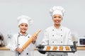 female chef and girl with cookies and rolling pin Royalty Free Stock Photo