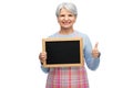 old woman in apron with menu showing thumbs up Royalty Free Stock Photo