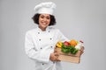 happy smiling female chef with food in wooden box Royalty Free Stock Photo