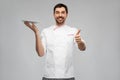 happy male chef with empty plate showing thumbs up Royalty Free Stock Photo