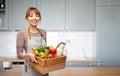 happy woman in apron with food in wooden box Royalty Free Stock Photo