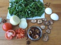 Cooking dandelion leaves omelette with mushrooms