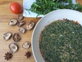 Cooking dandelion leaves omelette with mushrooms