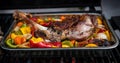Cooking a delicious leg of lamb on a BBQ with peppers and potatoes in metal tray Royalty Free Stock Photo