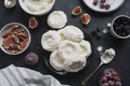 Cooking dessert. Abstract food background. Top view of mini Pavlova meringue cakes decorated with berries and figs